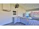 Bright sunroom boasts a bar area, a sink, and plenty of natural light with views of the backyard at 437 Merrimac Dr, Port Orange, FL 32127