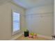 Spacious walk-in closet with white shelving, tile floors, and a window at 437 Merrimac Dr, Port Orange, FL 32127