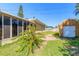 View of the house's backyard with a storage shed and a screened-in porch at 44 Sunset Blvd, Ormond Beach, FL 32176