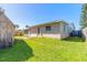 Exterior view of the house's backyard with a storage shed and patio at 44 Sunset Blvd, Ormond Beach, FL 32176