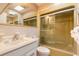 Retro bathroom with a sliding glass door shower, and updated sink and toilet at 44 Sunset Blvd, Ormond Beach, FL 32176