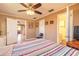 Bedroom featuring light tiled floors, ceiling fan and attached bathroom at 44 Sunset Blvd, Ormond Beach, FL 32176