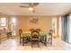 Bright dining room featuring large windows, a ceiling fan, and access to the outdoors at 44 Sunset Blvd, Ormond Beach, FL 32176