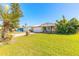 Charming home with stone accents, a well-maintained lawn and a metal roof at 44 Sunset Blvd, Ormond Beach, FL 32176