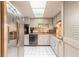 Traditional kitchen featuring white cabinetry, black appliances, and a bright skylight at 44 Sunset Blvd, Ormond Beach, FL 32176