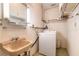 Functional laundry area with a utility sink, washer, and ample storage space at 44 Sunset Blvd, Ormond Beach, FL 32176
