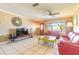 A bright living room featuring tile floors, ceiling fan, and a large window at 44 Sunset Blvd, Ormond Beach, FL 32176