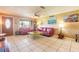 A bright living room featuring tile floors, ceiling fan, and a large window at 44 Sunset Blvd, Ormond Beach, FL 32176