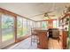 Bright sun room with tile floor and bar with multiple chairs at 44 Sunset Blvd, Ormond Beach, FL 32176