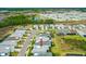 An aerial view displays a residential community with colorful homes, and is surrounded by picturesque scenery at 464 Tropics Ave, Daytona Beach, FL 32124