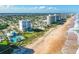 Aerial view of beachfront condos with community pools, plus beach access and ocean views at 464 Tropics Ave, Daytona Beach, FL 32124