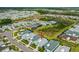 An aerial view of the property reveals a residential community with lush landscaping, and colorful homes at 464 Tropics Ave, Daytona Beach, FL 32124