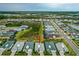 This aerial view shows the property within a vibrant community, surrounded by natural green spaces at 464 Tropics Ave, Daytona Beach, FL 32124