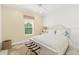 Cozy bedroom with neutral walls, ceiling fan, and natural light from the window at 464 Tropics Ave, Daytona Beach, FL 32124