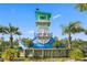 Community entrance featuring a nautical tower with tropical landscaping, plus Latitude Margaritaville signage at 464 Tropics Ave, Daytona Beach, FL 32124