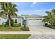 Charming single-Gathering home with a two-car garage, palm trees, and well-maintained landscaping at 464 Tropics Ave, Daytona Beach, FL 32124