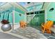 Charming entrance to the Latitude Beach Club with decorative doors and colorful accent furniture at 464 Tropics Ave, Daytona Beach, FL 32124