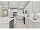 Spacious kitchen featuring white cabinetry, stainless steel appliances, and elegant marble flooring at 464 Tropics Ave, Daytona Beach, FL 32124
