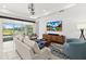 Comfortable living room with stylish furniture, large windows, and a view of the outdoor patio at 464 Tropics Ave, Daytona Beach, FL 32124