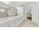 This bright main bathroom features a double vanity, shower, and access to the main bedroom at 464 Tropics Ave, Daytona Beach, FL 32124
