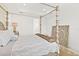 This light and airy main bedroom features a four-poster bed and an ensuite bath at 464 Tropics Ave, Daytona Beach, FL 32124