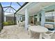 The screened patio has an outdoor dining area, cooler and sliding glass doors to the interior of the home at 464 Tropics Ave, Daytona Beach, FL 32124