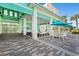 Community patio featuring a covered seating area with ample table space, plus tropical landscaping at 464 Tropics Ave, Daytona Beach, FL 32124