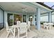 Enjoy outdoor dining on the screened in patio with ceiling fan and easy access to the home's interior at 464 Tropics Ave, Daytona Beach, FL 32124