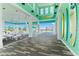 Inviting pool area with covered seating, tropical landscaping and decorative surfboards mounted on an accent wall at 464 Tropics Ave, Daytona Beach, FL 32124
