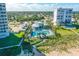 Aerial view of beachfront condos with community pools, plus beach access and neighborhood views at 464 Tropics Ave, Daytona Beach, FL 32124