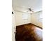 This bedroom is bright and spacious, with natural light from two windows and beautiful wood floors at 5076 Fairport Ave, De Leon Springs, FL 32130