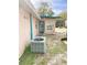 Back of home with air conditioner, door, and grassy lot at 5076 Fairport Ave, De Leon Springs, FL 32130