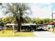 Charming one-story home featuring a spacious front yard with mature trees and a covered carport at 5076 Fairport Ave, De Leon Springs, FL 32130