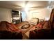 Cozy living room featuring wood floors, a ceiling fan, and ample space for seating arrangements at 5076 Fairport Ave, De Leon Springs, FL 32130