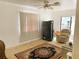 Living room featuring a ceiling fan, vertical blinds, and doorway to another room at 5076 Fairport Ave, De Leon Springs, FL 32130