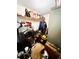 The storage room is equipped with a washing machine, a generator, and shelves for storage at 5076 Fairport Ave, De Leon Springs, FL 32130