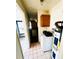 Utility room featuring a washer, a water heater, and cabinet at 5076 Fairport Ave, De Leon Springs, FL 32130