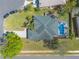 An elevated shot displays mature trees, manicured lawn, and a home with screened-in pool at 6 Greenvale Dr, Ormond Beach, FL 32174