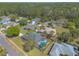 A quiet neighborhood is presented with manicured lawns, mature trees and beautiful homes at 6 Greenvale Dr, Ormond Beach, FL 32174