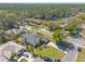 This aerial view shows the house, its large lot, and the surrounding neighborhood, full of trees and landscaping at 6 Greenvale Dr, Ormond Beach, FL 32174