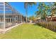 The home features a large backyard, with an in-ground screened pool and patio area, surrounded by mature landscaping at 6 Greenvale Dr, Ormond Beach, FL 32174