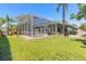 The lush backyard offers plenty of room to play, relax, and features a screened-in pool and patio area at 6 Greenvale Dr, Ormond Beach, FL 32174