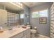 Bright bathroom featuring a white vanity, a large mirror, and a shower with a decorative curtain at 6 Greenvale Dr, Ormond Beach, FL 32174