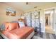 Inviting bedroom with hardwood floors, a comfortable bed with decorative pillows, and a view into the hallway at 6 Greenvale Dr, Ormond Beach, FL 32174