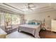 Inviting bedroom with a wicker headboard, tray ceiling, and decorative pillows on the bed at 6 Greenvale Dr, Ormond Beach, FL 32174