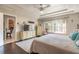 Relaxing bedroom showcasing a tray ceiling, wood floors, and a view to the pool at 6 Greenvale Dr, Ormond Beach, FL 32174
