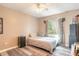 Simple bedroom with hardwood floors, natural light from the window, and neutral décor at 6 Greenvale Dr, Ormond Beach, FL 32174