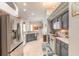 Spacious kitchen with stainless steel appliances, gray cabinets, and a functional layout at 6 Greenvale Dr, Ormond Beach, FL 32174