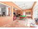 Large living area showcasing a pool table, living room, and natural light at 6 Greenvale Dr, Ormond Beach, FL 32174