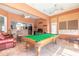 Bright and open living room featuring a pool table, comfortable seating, and ample natural light at 6 Greenvale Dr, Ormond Beach, FL 32174